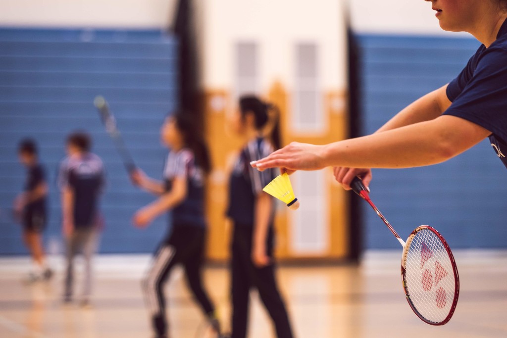 Joueur de badminton au service en salle